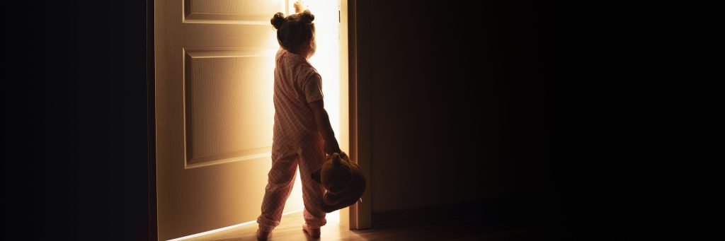 Little girl opens the door to the light in darkness., nightmare, sleep problems, sleep disorder, awake