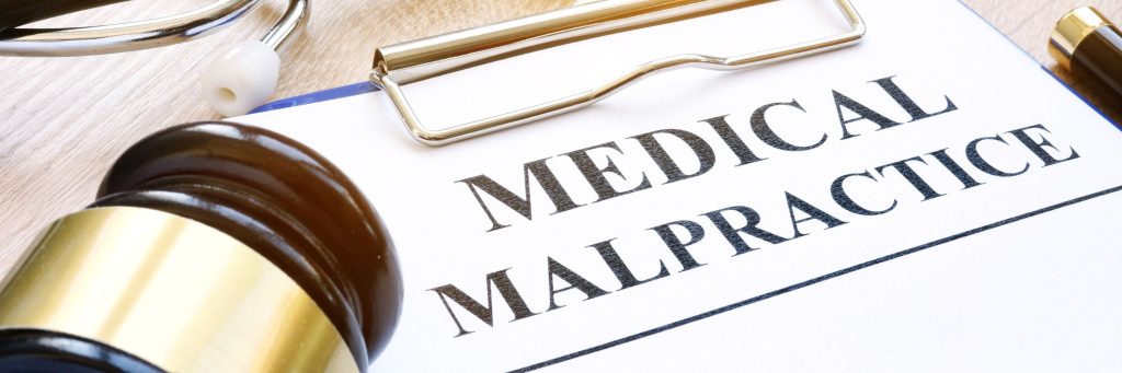 Clipboard with documents about medical malpractice and gavel. Claim, lawsuit, medmal, photo