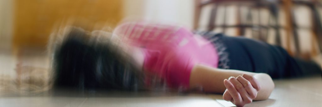 seizure, Woman lying on the floor at home, epilepsy, unconsciousness, faint, stroke, accident