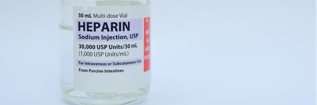 Vial of Heparin Sodium Injection on white background