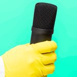 A doctor in a medical gown and protective gloves holds a microphone. interview, share experiences