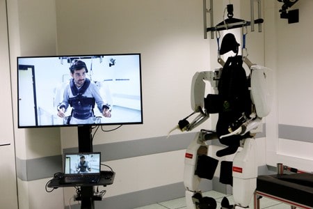 Paralyzed man hails ‘feat’ of walking again with robot exoskeleton