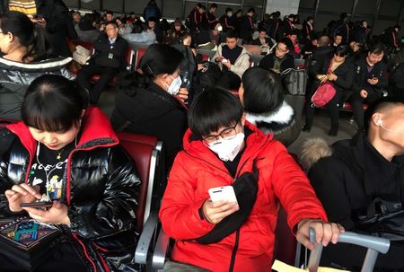As virus spreads to more Chinese cities, WHO calls emergency meeting