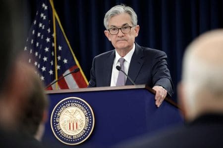 Fed has a role in combating climate change risk, Powell says