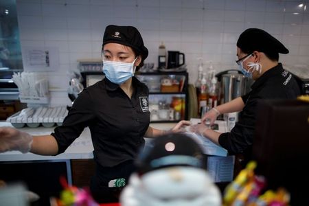 Eating solo, avoiding rush hour: China cautiously returns to work