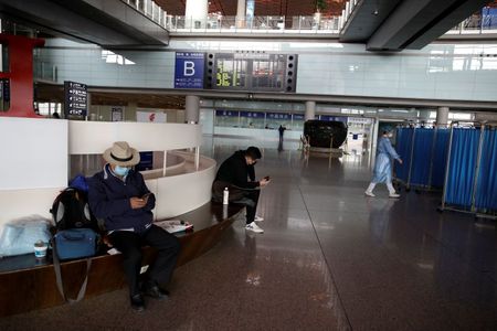 China sees fewer coronavirus cases, wary of international travellers