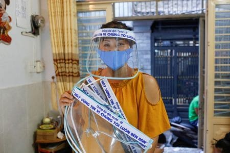 Vietnamese hat seller turns to homemade face shields in virus fight